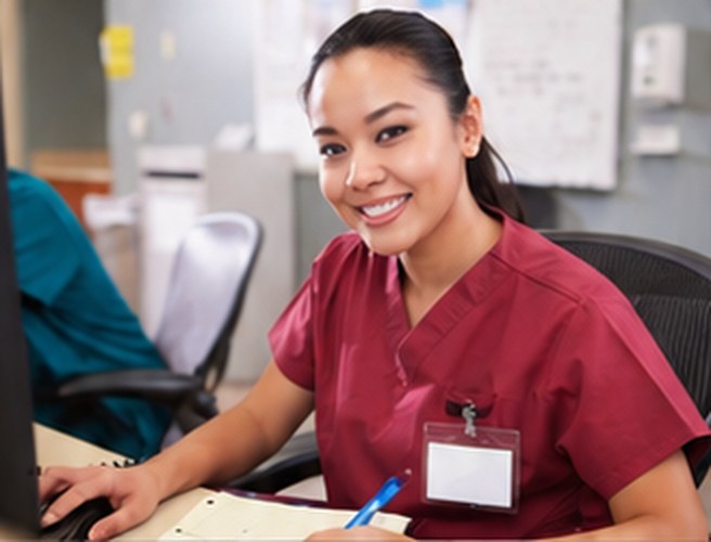 Smiling Ardent Home Care nurse at her desk